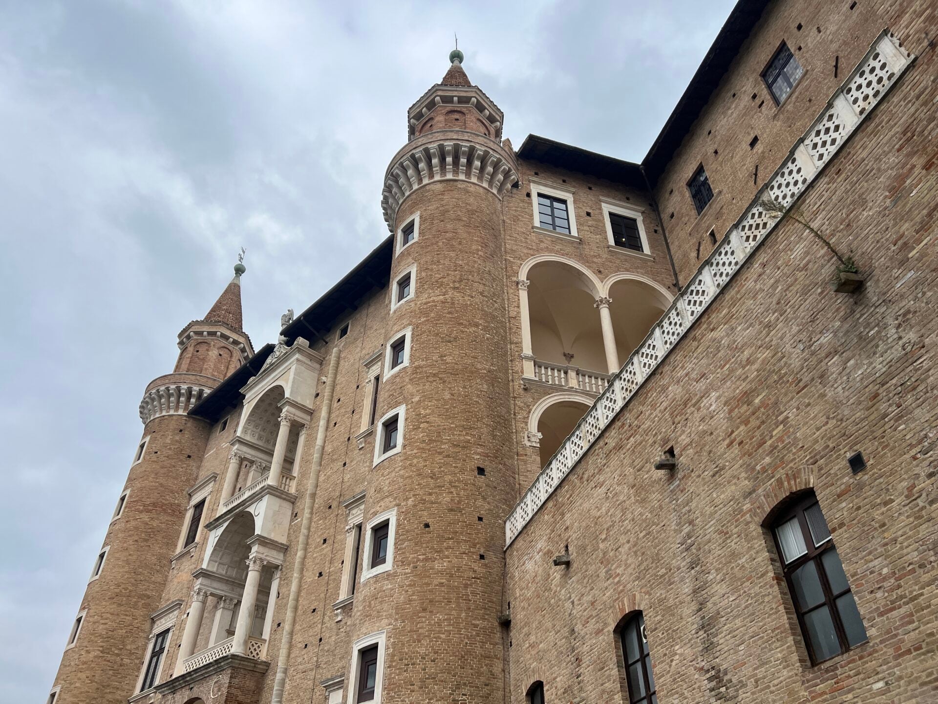Historic castle with tall brick towers and arches.
