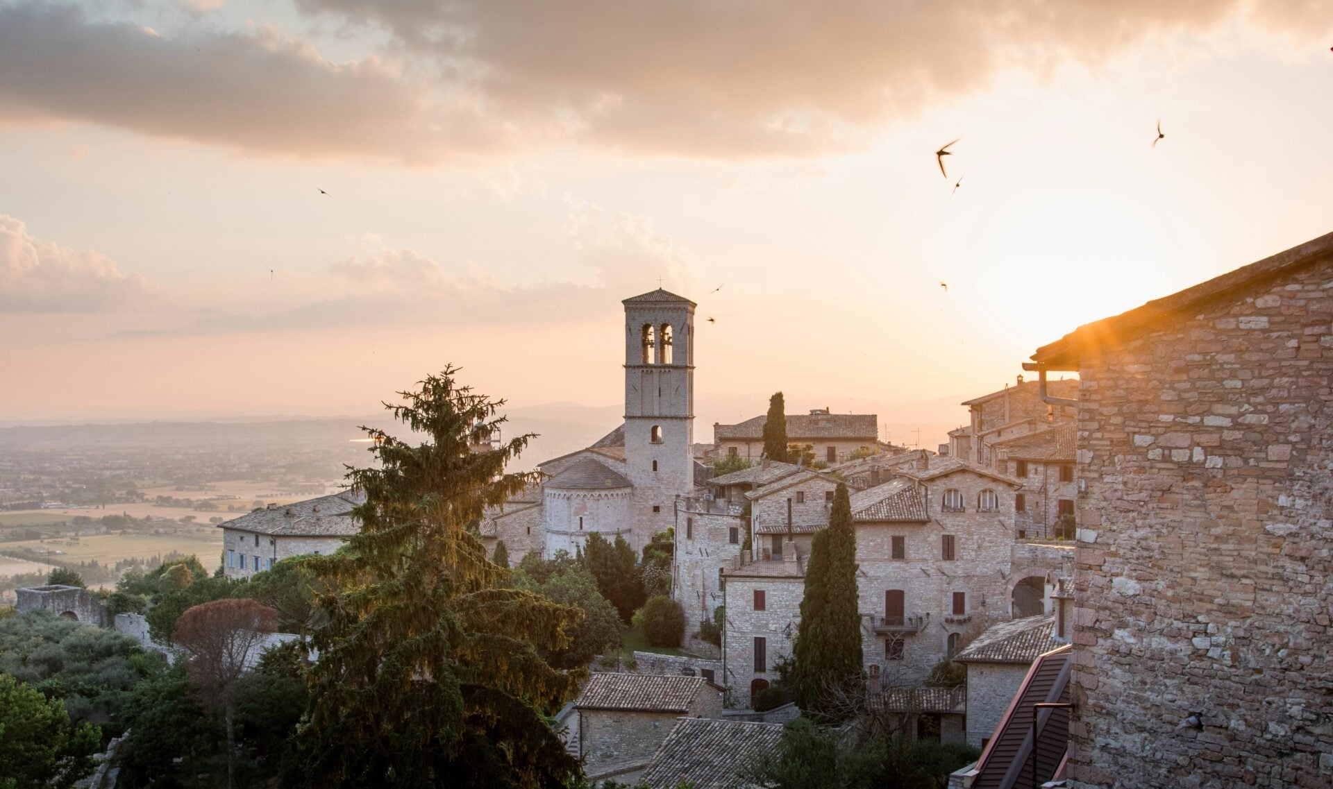 Sunset over Italian village with stone buildings.